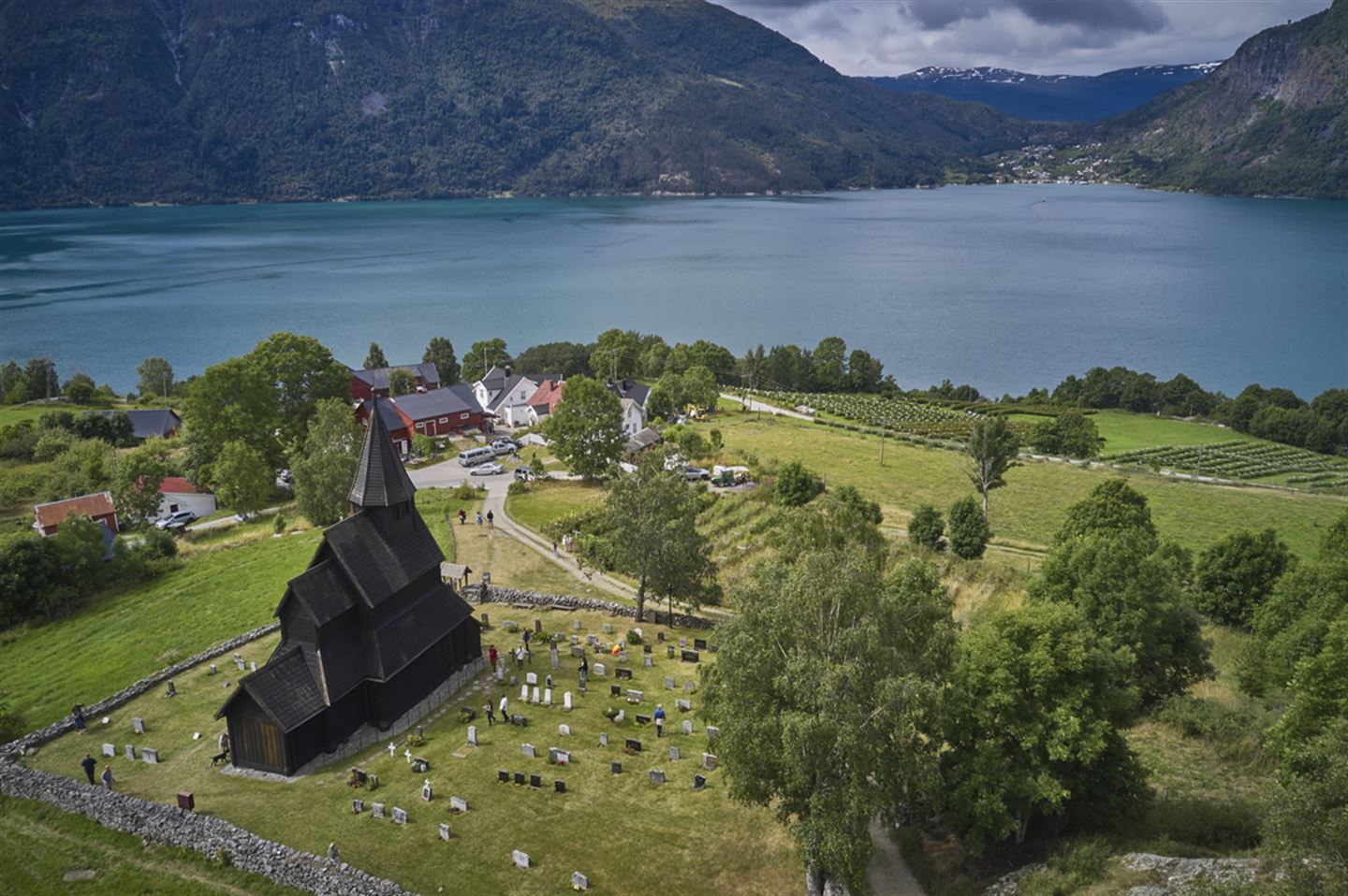 Dronebilde av Urnes stavkyrkje, med utsikt mot Lustrafjorden og Solvorn.